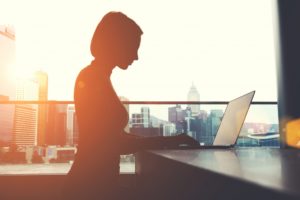 silhouette of working woman on a city background