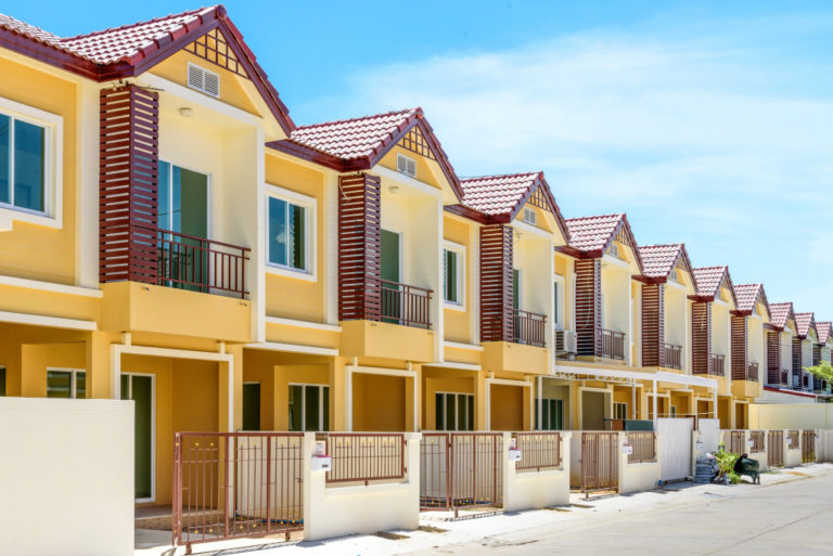 beige maroon-roofed townhouses