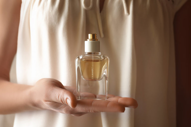 holding a fragrance bottle