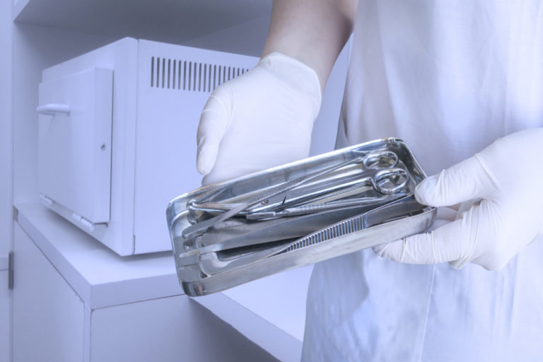 personnel sterilizing dental tools