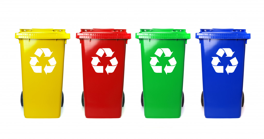 Four colorful recycling bins with a white background.
