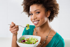 a woman eating vegetables
