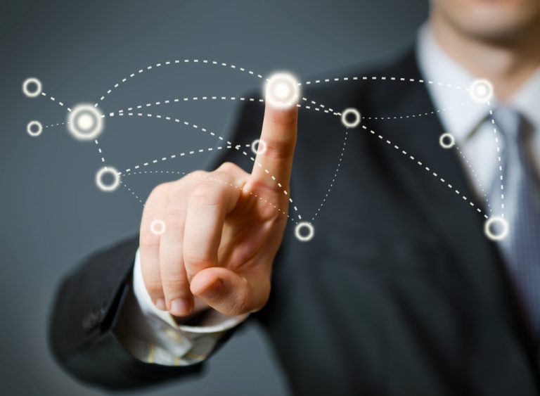 A man in a business suit touching one of the virtual circles