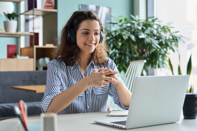 Young woman working remotely using a laptop.