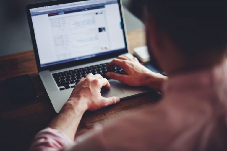 Male freelancer working at home using a laptop.