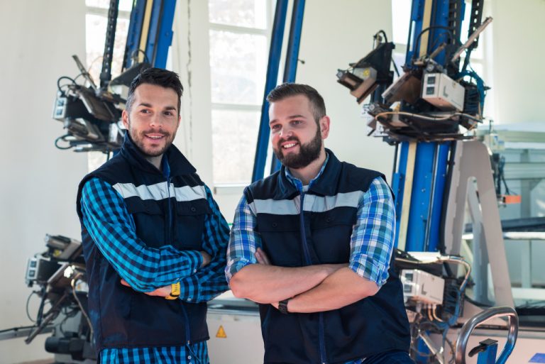 Manufacturing plant workers pose for the camera