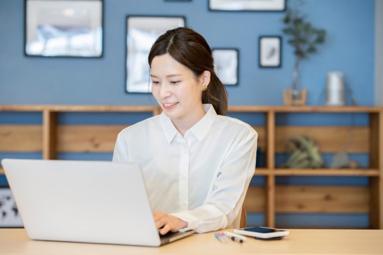 a woman typing on her laptop