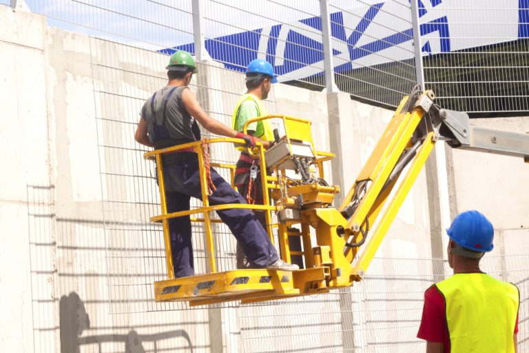 construction workers in hydraulic platform