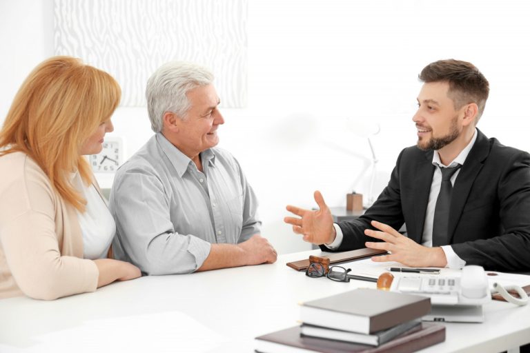 man talking to two aged people